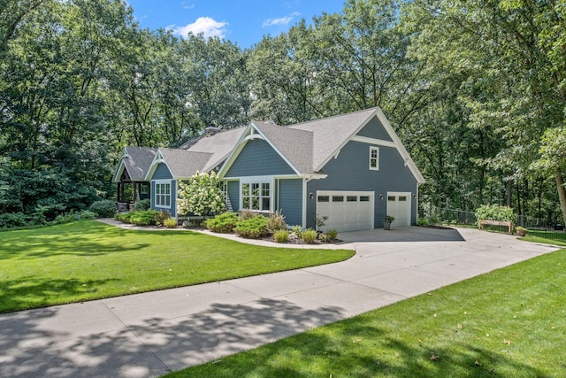 7979 Ella Terrace Dr, Rockford, MI 49341 - view of front facade featuring an attached garage, driveway, and view of scattered trees