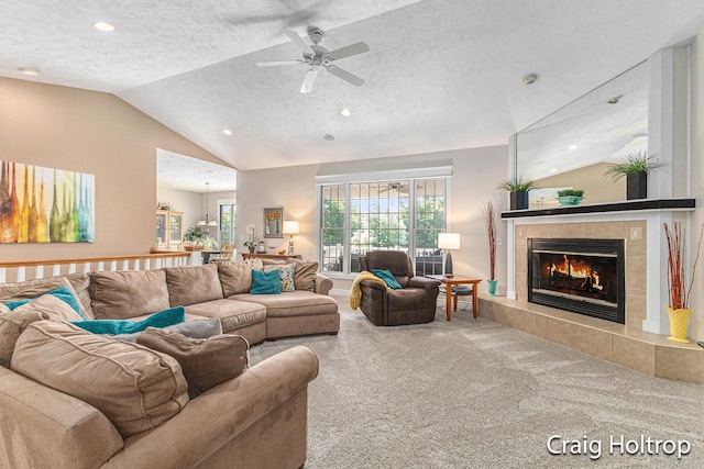 3566 Little Timber Ct SW, Grand Rapids, MI 49534 - carpeted living room with a textured ceiling, a ceiling fan, a tile fireplace, lofted ceiling, and recessed lighting