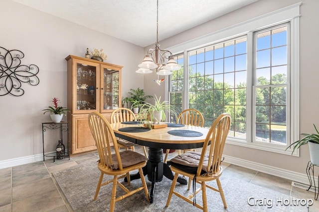 3566 Little Timber Ct SW, Grand Rapids, MI 49534 - dining room featuring a chandelier and light tile patterned floors