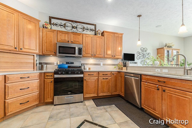 3566 Little Timber Ct SW, Grand Rapids, MI 49534 - kitchen featuring stainless steel appliances, decorative backsplash, light countertops, decorative light fixtures, and a textured ceiling
