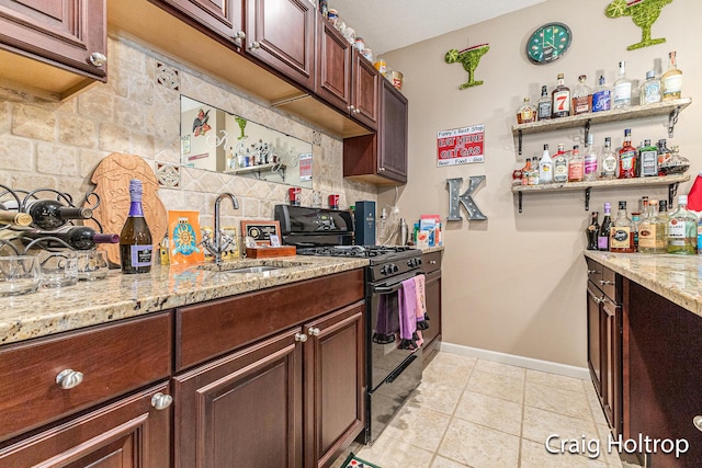 3566 Little Timber Ct SW, Grand Rapids, MI 49534 - kitchen featuring black range, light tile patterned floors, tasteful backsplash, and light stone countertops