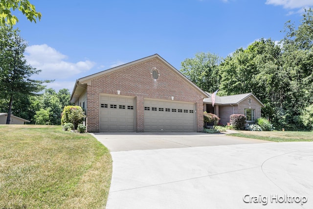 3566 Little Timber Ct SW, Grand Rapids, MI 49534 - view of front of home featuring brick siding, driveway, an attached garage, and a front yard