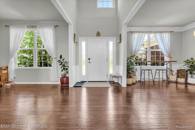 1043 Kendall Ct, Lake Orion, MI 48360 - entrance foyer featuring wainscoting, wood finished floors, and a high ceiling