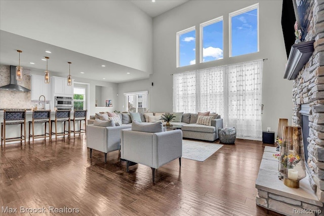1043 Kendall Ct, Lake Orion, MI 48360 - living room with dark wood-style flooring, a high ceiling, and recessed lighting