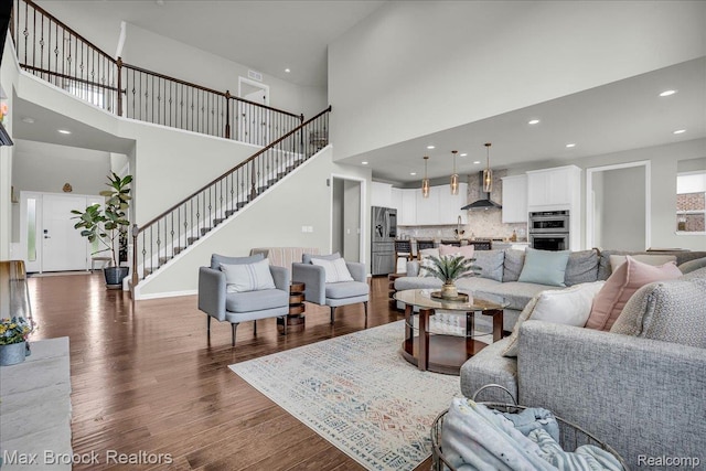 1043 Kendall Ct, Lake Orion, MI 48360 - living area with a high ceiling, dark wood-style flooring, stairway, and recessed lighting