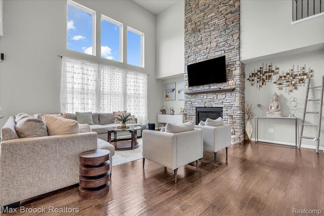 1043 Kendall Ct, Lake Orion, MI 48360 - living room featuring a high ceiling, wood finished floors, and a stone fireplace