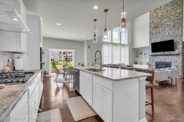 1043 Kendall Ct, Lake Orion, MI 48360 - kitchen featuring ventilation hood, stainless steel appliances, dark wood-style flooring, white cabinetry, and recessed lighting