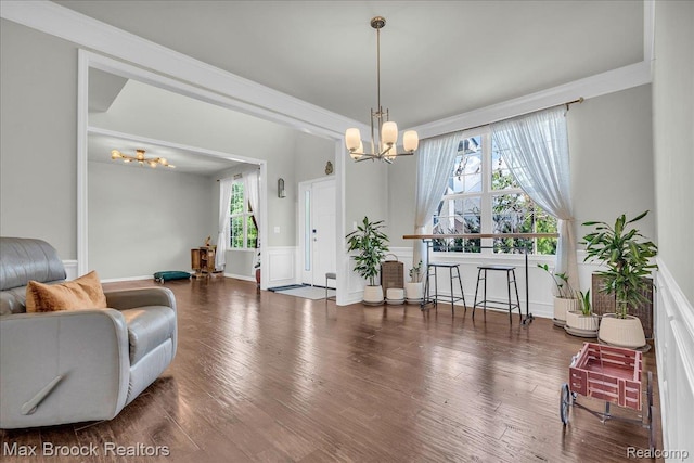 1043 Kendall Ct, Lake Orion, MI 48360 - living room featuring a chandelier, wood finished floors, and a wainscoted wall