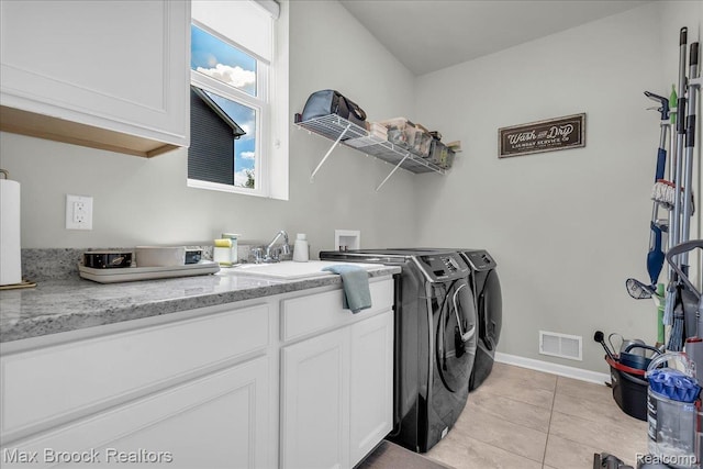 1043 Kendall Ct, Lake Orion, MI 48360 - laundry room with independent washer and dryer, light tile patterned flooring, and cabinet space