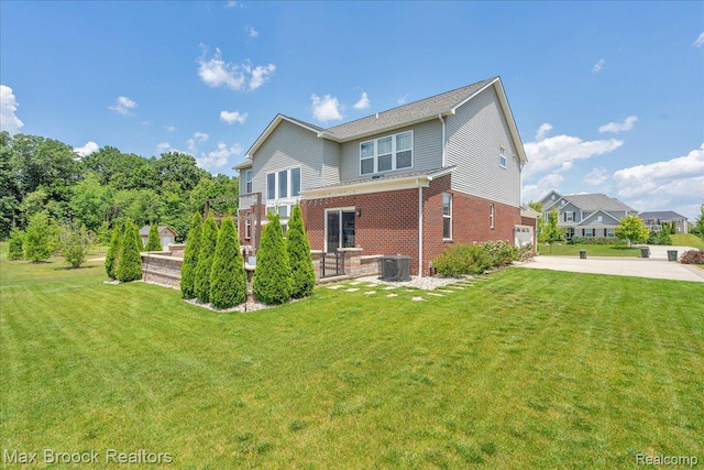 1043 Kendall Ct, Lake Orion, MI 48360 - rear view of house featuring brick siding, concrete driveway, a lawn, and a garage