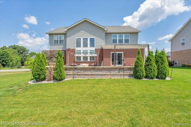 1043 Kendall Ct, Lake Orion, MI 48360 - rear view of house with brick siding and a lawn