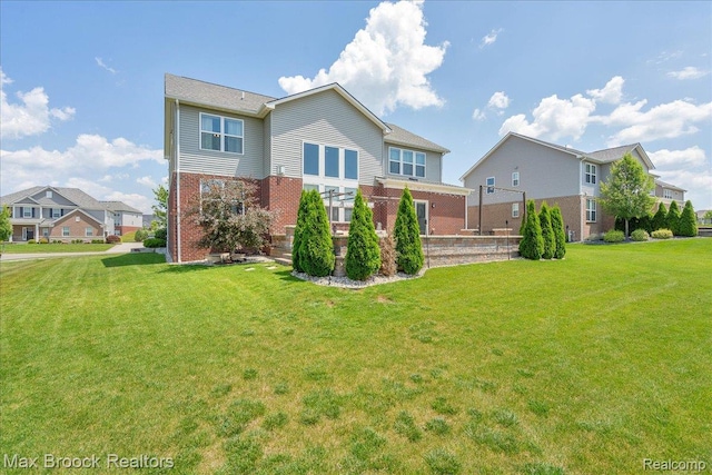 1043 Kendall Ct, Lake Orion, MI 48360 - back of house with brick siding and a lawn