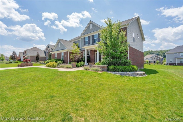 1043 Kendall Ct, Lake Orion, MI 48360 - view of front of house featuring brick siding, a front yard, and a residential view
