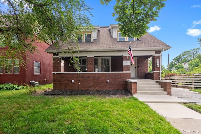 1725 Seyburn St, Detroit, MI 48214 - bungalow with covered porch, brick siding, and roof with shingles