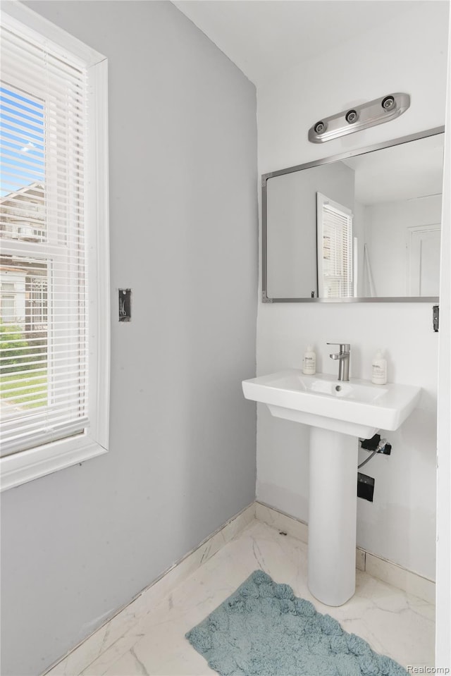 1725 Seyburn St, Detroit, MI 48214 - bathroom featuring marble look tiles and plenty of natural light