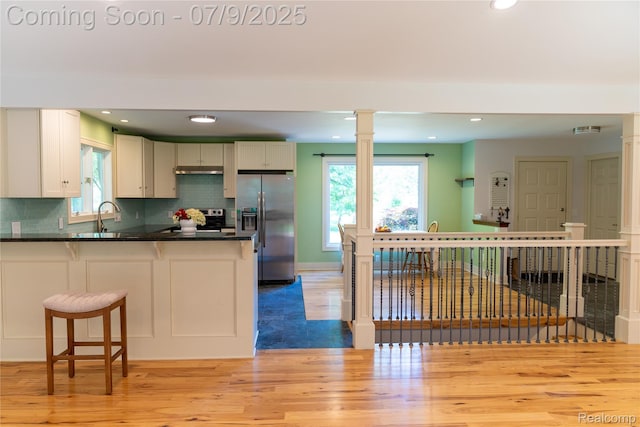 3580 Hazelton Ave, Rochester Hills, MI 48307 - kitchen featuring stainless steel appliances, a peninsula, dark countertops, light wood-style flooring, and recessed lighting