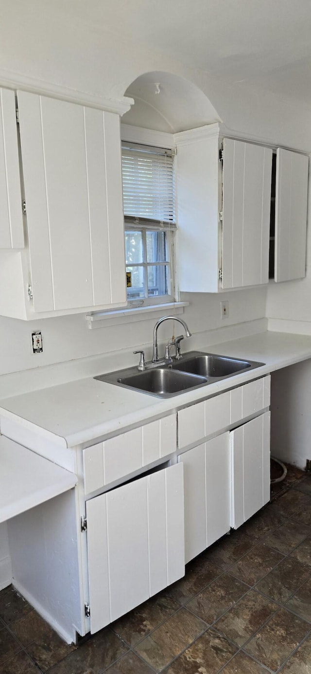 15744 Ferguson St, Detroit, MI 48227 - kitchen featuring white cabinetry, light countertops, and dark stone finish floors