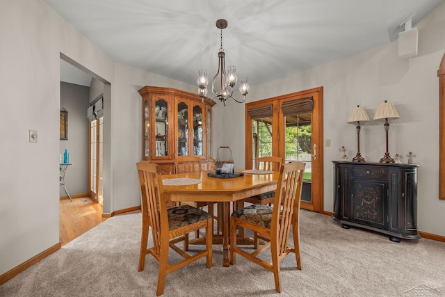 1381 Briarson Dr, Saginaw, MI 48638 - dining room featuring light colored carpet and a chandelier