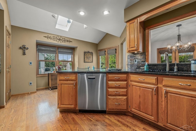 1381 Briarson Dr, Saginaw, MI 48638 - kitchen with stainless steel dishwasher, brown cabinets, a skylight, light wood finished floors, and vaulted ceiling