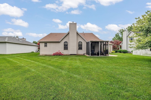 1381 Briarson Dr, Saginaw, MI 48638 - back of property featuring a sunroom, a yard, and a chimney