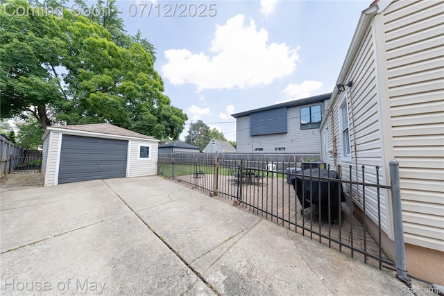 1943 Hazel St, Birmingham, MI 48009 - view of patio featuring a garage and an outbuilding
