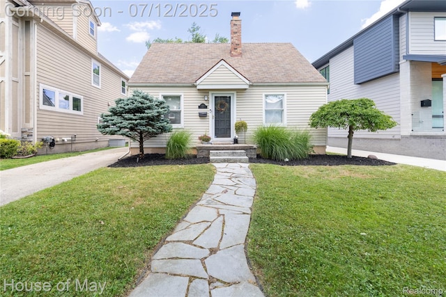 1943 Hazel St, Birmingham, MI 48009 - view of front of house featuring a front lawn, roof with shingles, and a chimney