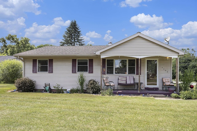 5468 Wellesley Dr, Jackson, MI 49201 - view of front of property with covered porch, a front yard, and a shingled roof