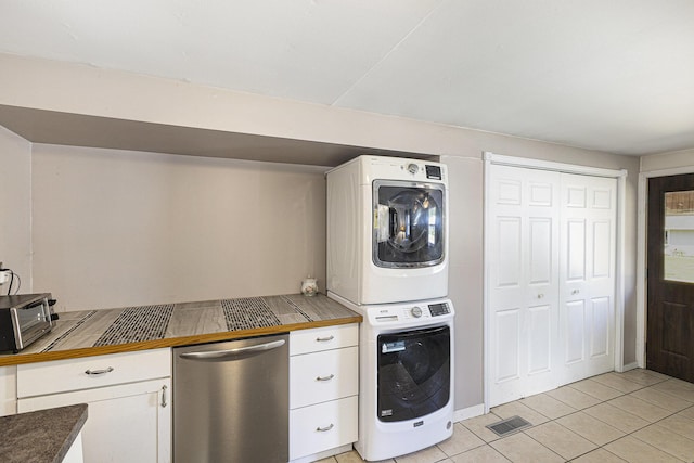 5468 Wellesley Dr, Jackson, MI 49201 - washroom with stacked washer / drying machine and light tile patterned floors