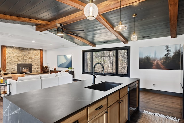 9442 Community Hall Rd, Union Pier, MI 49129 - kitchen featuring dark wood-type flooring, a ceiling fan, a wooden ceiling with exposed beams, pendant lighting, and open floor plan