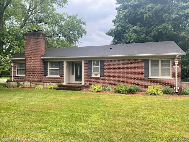 41079 E Ann Arbor Trl, Plymouth, MI 48170 - ranch-style house featuring a chimney, a front lawn, and brick siding