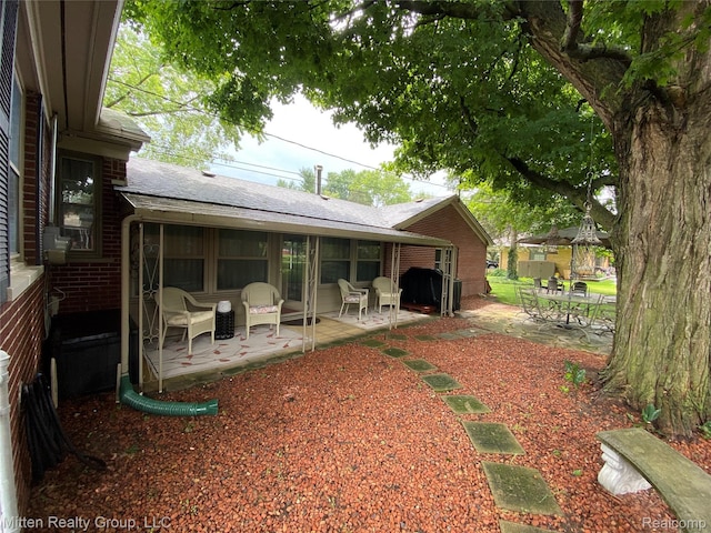 41079 E Ann Arbor Trl, Plymouth, MI 48170 - rear view of property with a patio and a shingled roof