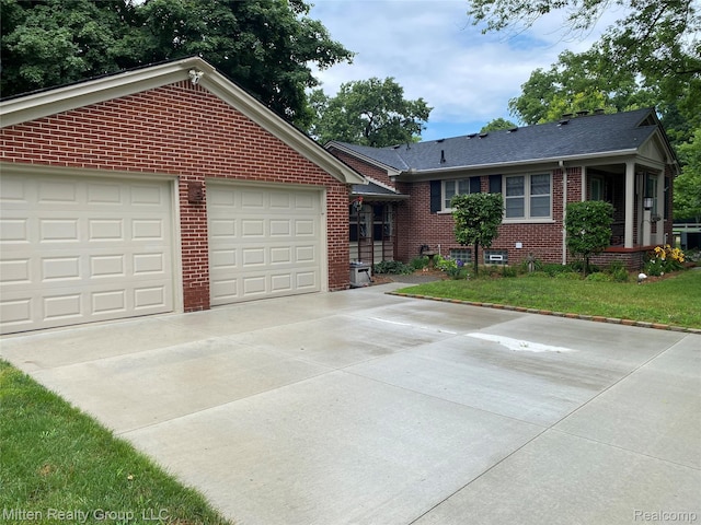 41079 E Ann Arbor Trl, Plymouth, MI 48170 - ranch-style house featuring brick siding, concrete driveway, and a garage