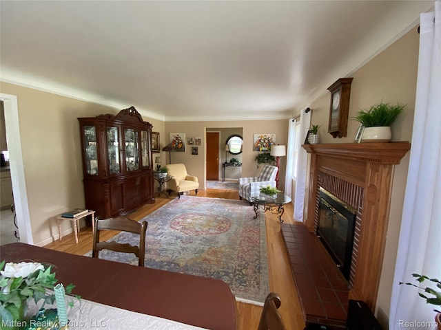 41079 E Ann Arbor Trl, Plymouth, MI 48170 - living room with light wood-style floors, a brick fireplace, and crown molding