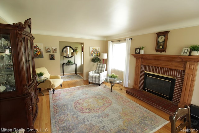 41079 E Ann Arbor Trl, Plymouth, MI 48170 - living room featuring wood finished floors, a brick fireplace, and crown molding