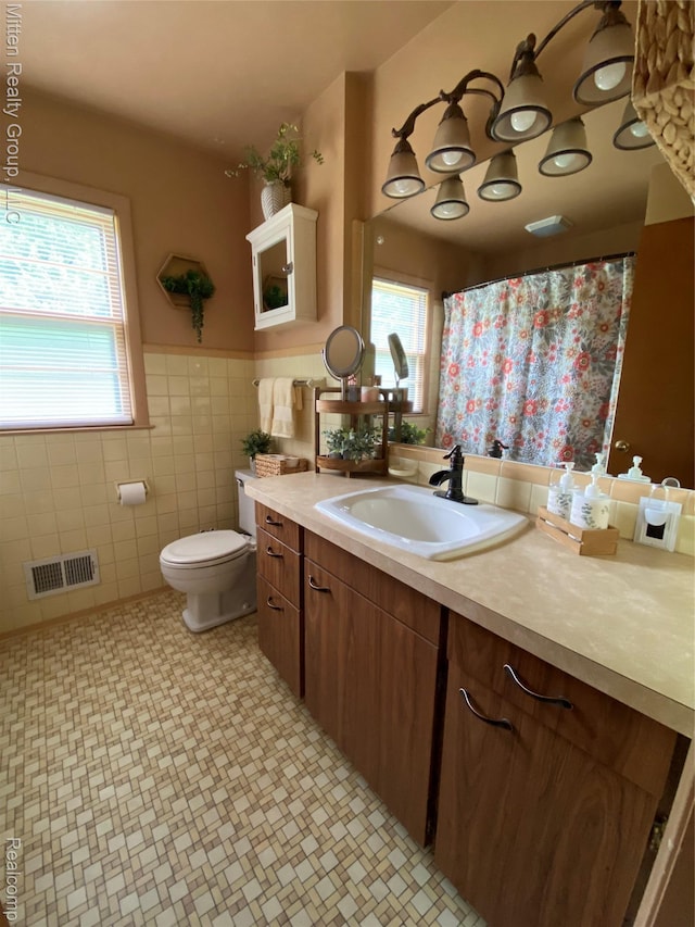 41079 E Ann Arbor Trl, Plymouth, MI 48170 - full bathroom with vanity, tile walls, a wainscoted wall, tile patterned floors, and a shower with shower curtain