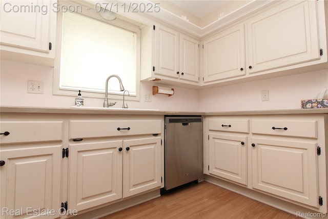 53347 Mark Dr, Shelby Twp, MI 48316 - kitchen with stainless steel dishwasher, light countertops, light wood-style flooring, and white cabinetry