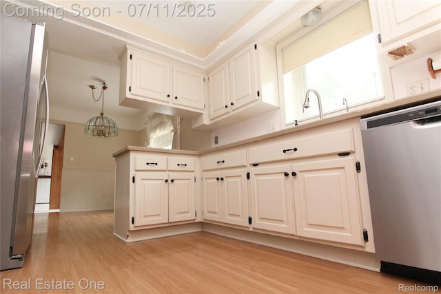 53347 Mark Dr, Shelby Twp, MI 48316 - kitchen featuring appliances with stainless steel finishes, light wood finished floors, a chandelier, light countertops, and decorative light fixtures