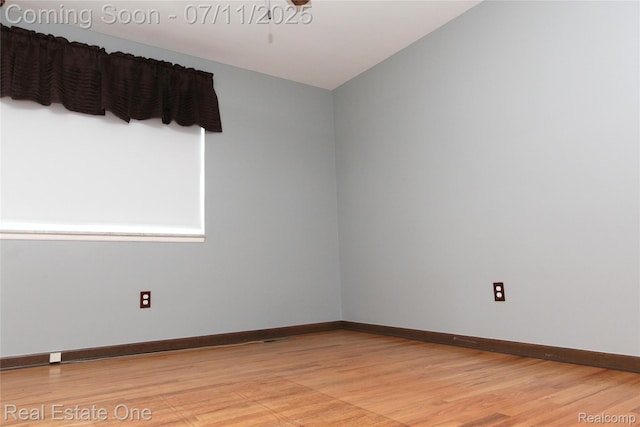 53347 Mark Dr, Shelby Twp, MI 48316 - spare room with light wood finished floors and lofted ceiling