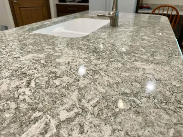 308 W Hosmer St, Saint Charles, MI 48655 - detailed view of stone countertops and a sink