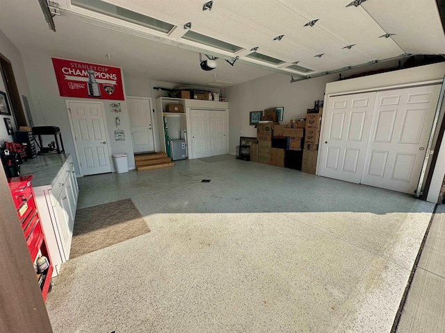 308 W Hosmer St, Saint Charles, MI 48655 - garage featuring a garage door opener and refrigerator
