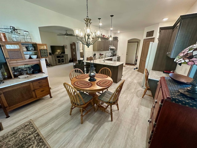 308 W Hosmer St, Saint Charles, MI 48655 - dining room with arched walkways, a ceiling fan, light wood-style flooring, a chandelier, and recessed lighting