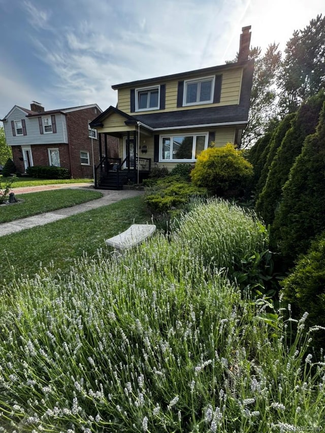 1036 Irving Ave, Royal Oak, MI 48067 - traditional home featuring a chimney, a porch, and a front yard