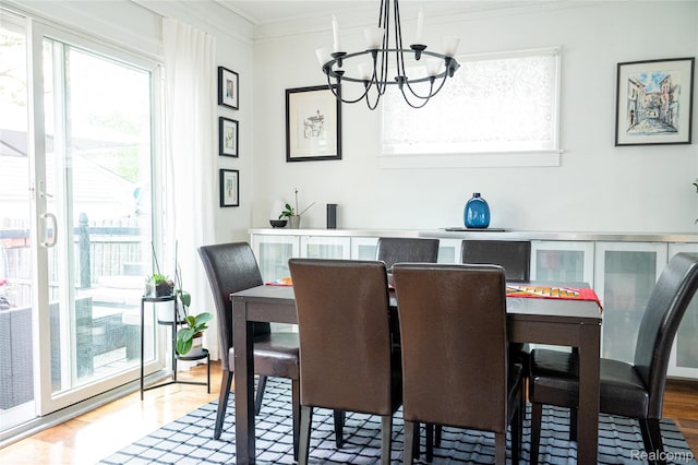 1036 Irving Ave, Royal Oak, MI 48067 - dining area with crown molding, a chandelier, and wood finished floors
