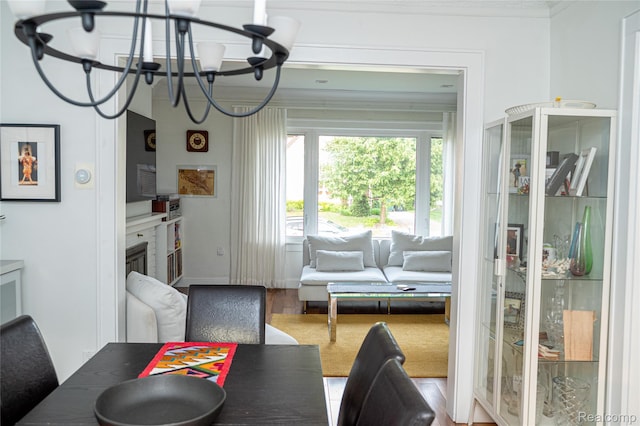 1036 Irving Ave, Royal Oak, MI 48067 - dining area featuring a chandelier, crown molding, wood finished floors, and a glass covered fireplace