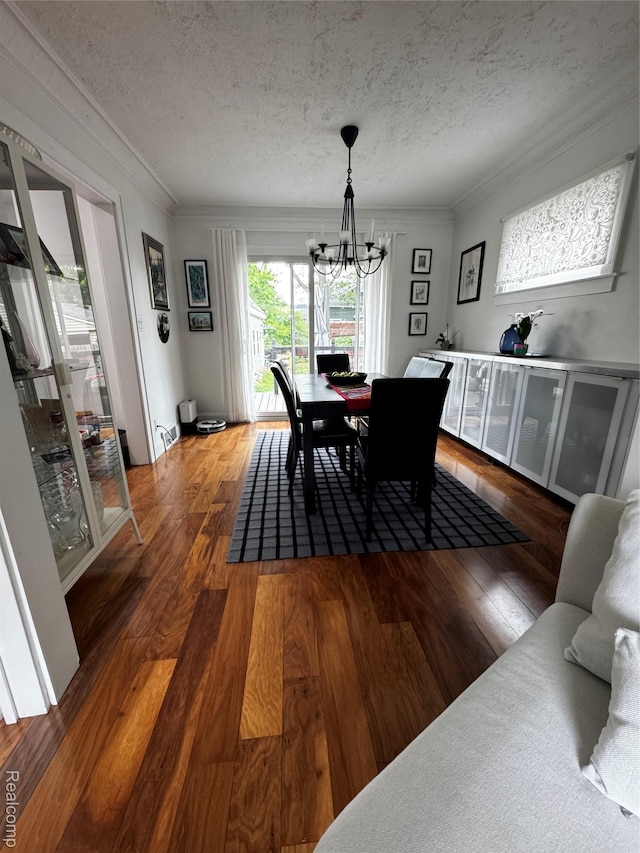 1036 Irving Ave, Royal Oak, MI 48067 - dining space with a chandelier, a textured ceiling, hardwood / wood-style floors, and ornamental molding