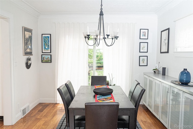 1036 Irving Ave, Royal Oak, MI 48067 - dining space with a chandelier, wood finished floors, ornamental molding, and healthy amount of natural light