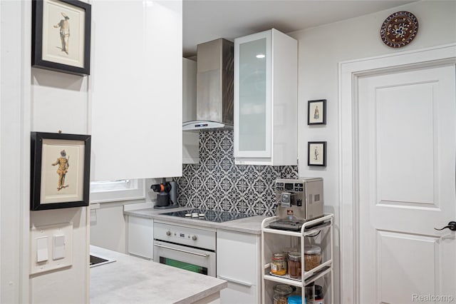 1036 Irving Ave, Royal Oak, MI 48067 - kitchen featuring oven, wall chimney exhaust hood, black electric cooktop, and white cabinets