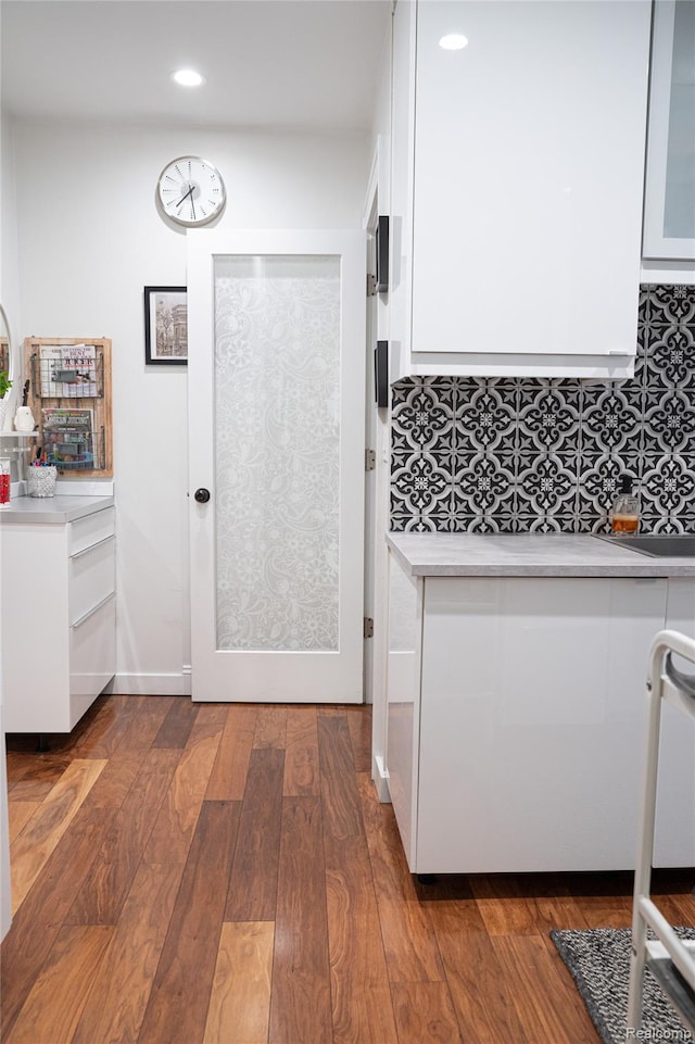 1036 Irving Ave, Royal Oak, MI 48067 - kitchen featuring light countertops, white cabinetry, dark wood-style flooring, recessed lighting, and tasteful backsplash