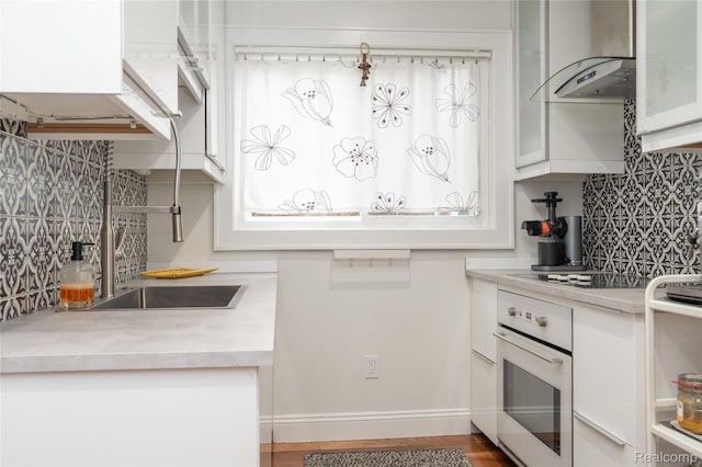 1036 Irving Ave, Royal Oak, MI 48067 - kitchen with oven, tasteful backsplash, white cabinetry, and light countertops