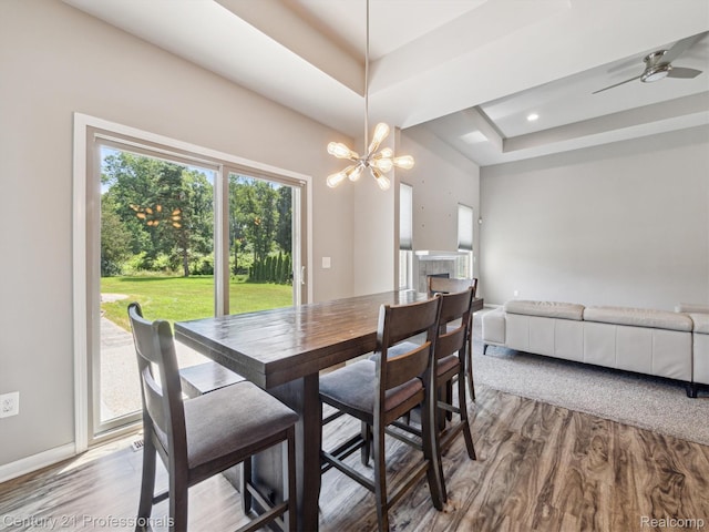 2655 Devondale Rd, Rochester Hills, MI 48309 - dining space with a raised ceiling, wood finished floors, a chandelier, and a fireplace